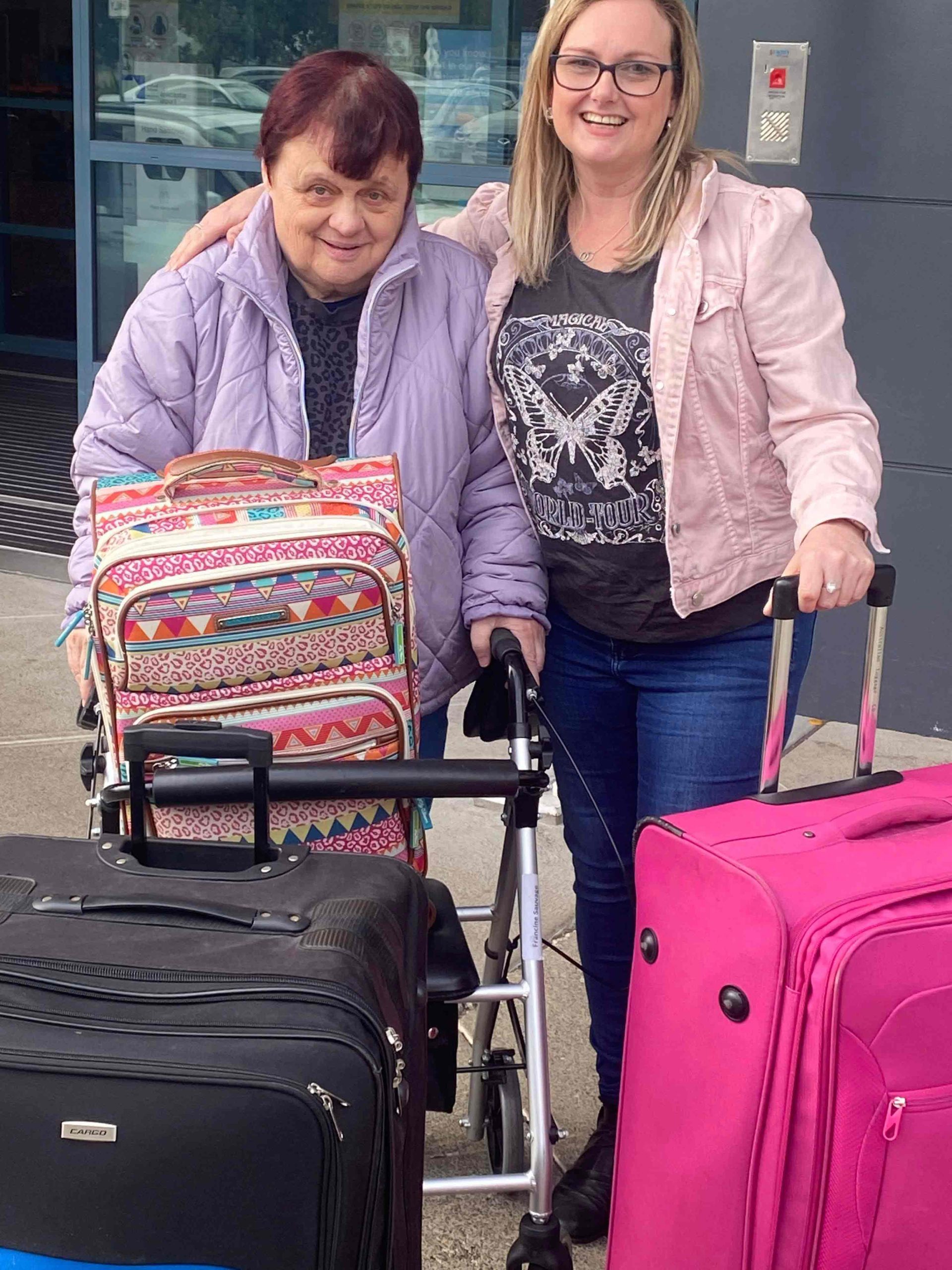 Two women with several suitcases.