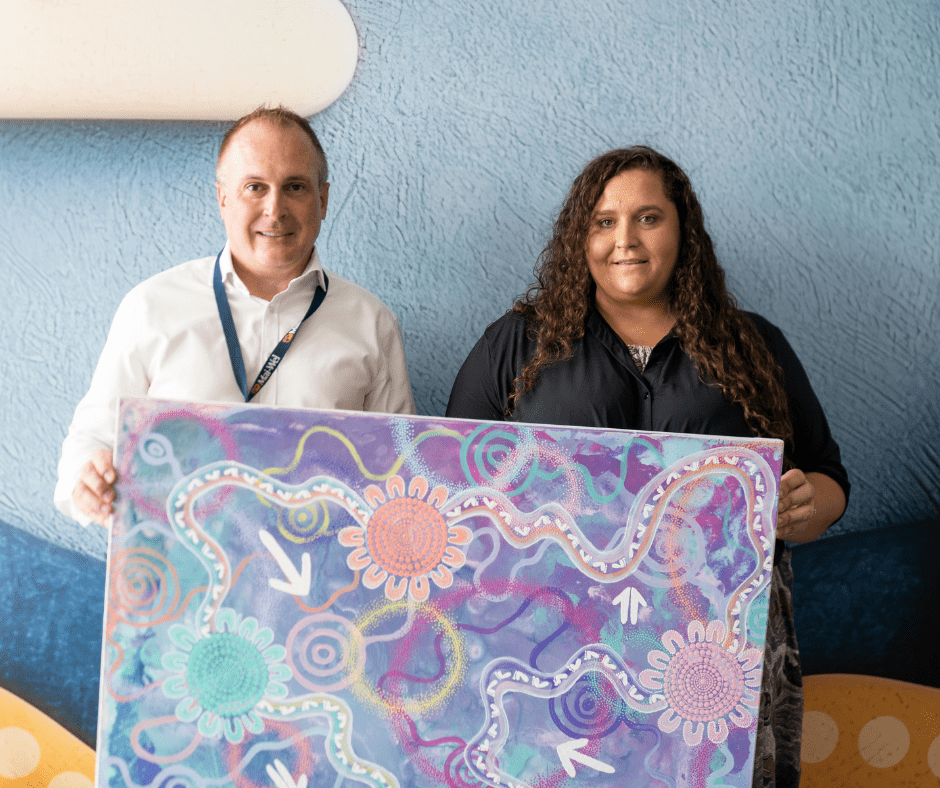 Build Presentation CEO John Cleary and artist Jess Sulter holding the "Build" artwork.