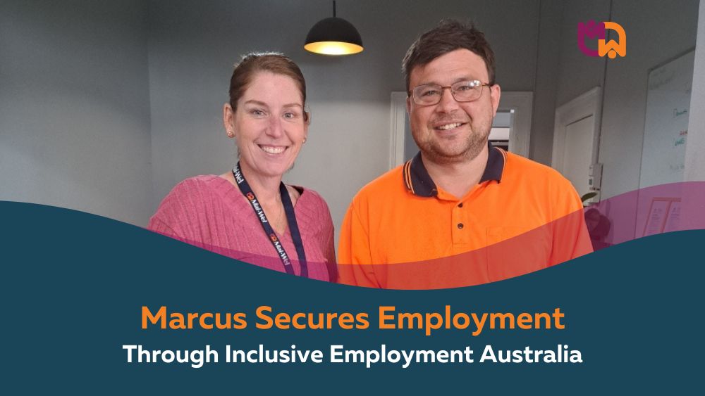 Marcus smiles alongside his Employment Coach Kate at Mai-Wel, with Marcus wearing his orange high visibility work shirt. Text overlay reads "Marcus Secures Employment Through Inclusive Employment Australia."